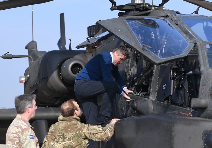 Williamson climbing into the cockpit of an Apache helicopter at Wattisham Airfield in Suffolk, as they head to the Baltics for a three-month deployment.