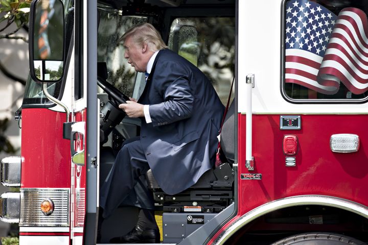 Trump plays in a fire truck while participating in a Made in America event in 2017.