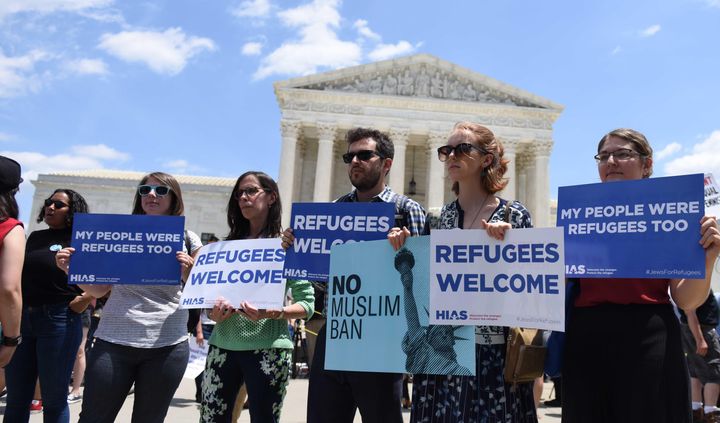 People protest the Muslim travel ban outside of the U.S. Supreme Court on June 26, 2018, in Washington.