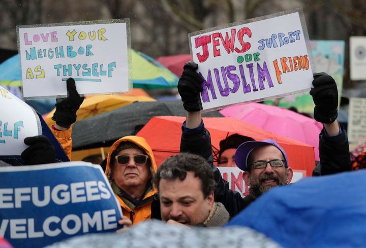 Demonstrators hold up signs during a rally in Battery Park organized by the Hebrew Immigrant Aid Society to mark a National Day of Jewish Action for Refugees on Feb. 12, 2017, in New York City.