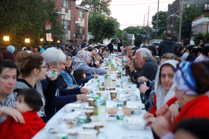 Muslims gather at an iftar dinner in the street organized by Bergen Diyanet Mosque and Cultural Center during the holy month of Ramadan in Cliffside Park, New Jersey, United States on June 11, 2018. 