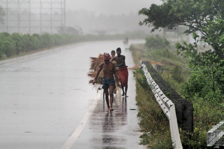 Villagers move to safer places amidst gusty winds preceding the landfall of cyclone Fani on the outskirts of Puri, in the Indian state of Odisha. (AP Photo)