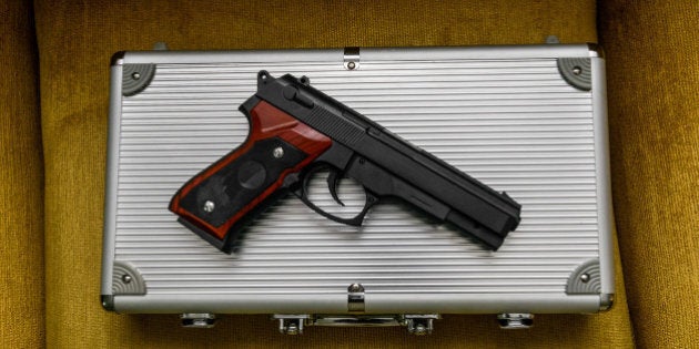 Pistol on a silver briefcase