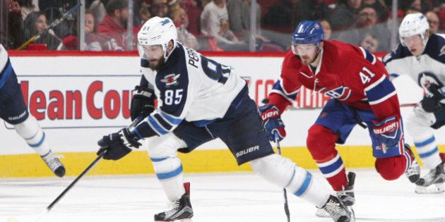 Feb 18, 2017; Montreal, Quebec, CAN; Winnipeg Jets center Mathieu Perreault (85) plays the puck against Montreal Canadiens left wing Paul Byron (41) during the second period at Bell Centre. Mandatory Credit: Jean-Yves Ahern-USA TODAY Sports
