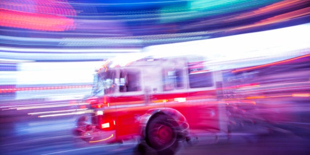 Fire truck rushing down 7th Avenue at night, Times Square, Manhattan, New York City, long exposure