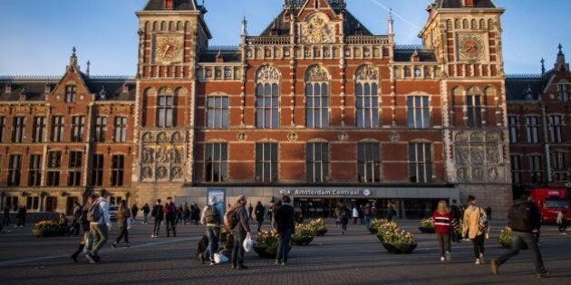 View of the Central Train Station of Amsterdam at sunset on April 11, 2017. / AFP PHOTO / Aurore Belot (Photo credit should read AURORE BELOT/AFP/Getty Images)