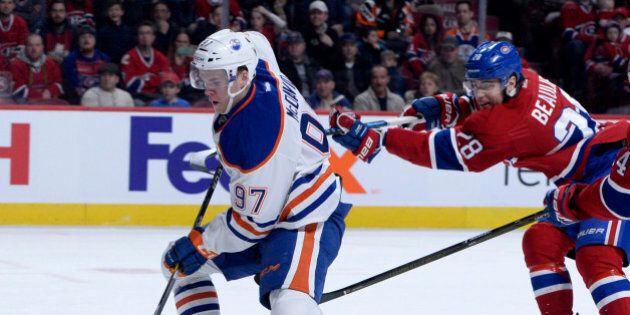 Feb 5, 2017; Montreal, Quebec, CAN; Montreal Canadiens defenseman Nathan Beaulieu (28) skates with the puck in front of Edmonton Oilers forward Connor McDavid (97) during the first period at the Bell Centre. Mandatory Credit: Eric Bolte-USA TODAY Sports