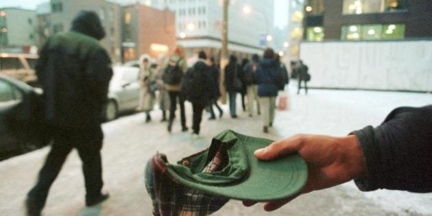 MONTREAL, CANADA: A homeless man begs in downtown Montreal 20 January, 2000 as the temperature remained below minus 10 celsius. Another homeless person died of exposure Monday in Montreal. Passersby, attempting to help, allege an Urgences Sante (emergency services) operator told them it was not yet an emergency while the man was still conscious. AFP PHOTO/Marcos TOWNEND (Photo credit should read MARCOS TOWNSEND/AFP/Getty Images)