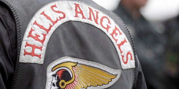 Police officers guard members of the rocker gang Hells Angels at the entrance of the district court in Duisburg, Germany, Monday, Aug. 30, 2010. A member of the Hells Angels is convicted of killing a member of the Bandidos, a rival rocker organization. (AP Photo/Frank Augstein)