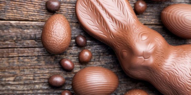 Delicious chocolate Easter bunny and eggs on wooden backgroundDelicious chocolate Easter bunny and eggs on wooden background
