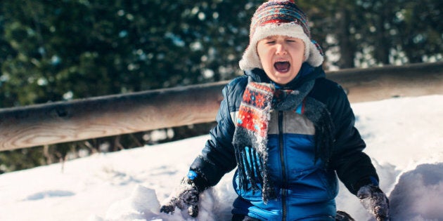 Little boy on snow crying