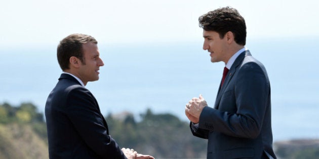 Canadian Prime Minister Justin Trudeau (R) and French President Emmanuel Macron talk as they attend the G7 Summit Taormina, Sicily, Italy, May 26, 2017. REUTERS/Stephane De Sakutin/Pool