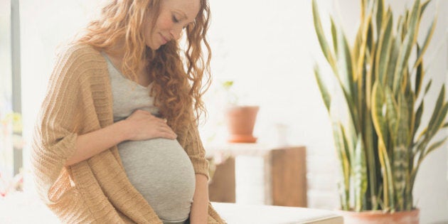 Pregnant woman holding stomach