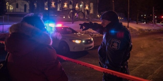 A Canadian police officer talks to a woman after a shooting in a mosque at the QuÃ©bec City Islamic cultural center on Sainte-Foy Street in Quebec city on January 29, 2017.Two arrests have been made after five people were reportedly shot dead in an attack on a mosque in QuÃ©bec City, Canada. / AFP / Alice Chiche (Photo credit should read ALICE CHICHE/AFP/Getty Images)