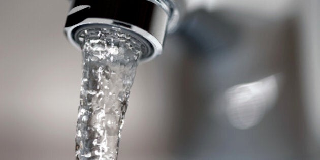 Faucet close-up with running water.