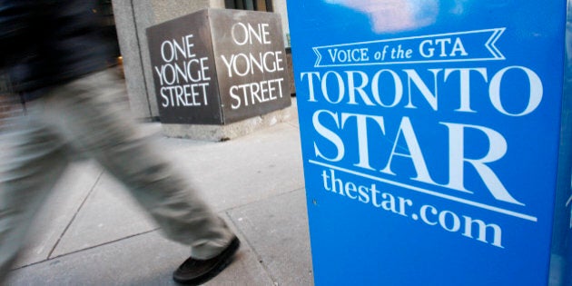 A pedestrian walks past a Toronto Star newspaper box in front of the Toronto Star building at One Yonge Street in Toronto January 18, 2008. Unionized employees at the Toronto Star, Canada's biggest daily newspaper, have overwhelmingly voted in favor of a strike and could be off the job as early as this weekend if contract talks fail to lead to a deal. REUTERS/Mark Blinch (CANADA)