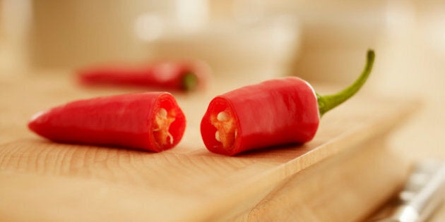 Close up of red chili peppers on cutting board