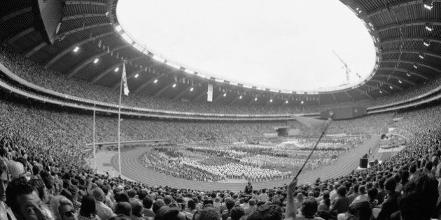 The curving Olympic Stadium of Montreal is filled to capacity during the opening ceremony of the 21st Olympic Games in Montreal, July 17, 1976. Delegations of the countries taking part in the Olympics crowd the stadium grounds as the Games are declared open. (AP Photo)