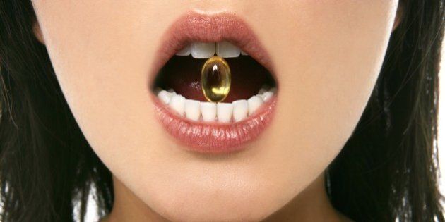 Close-up of a capsule in a woman's mouth