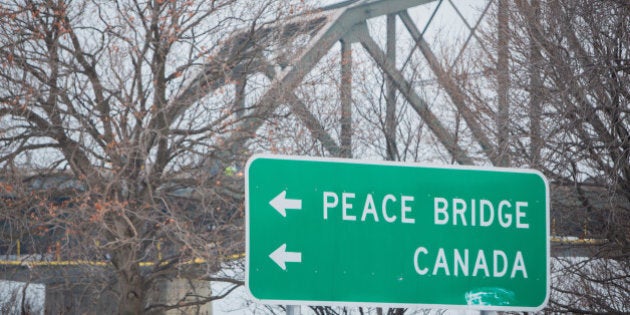 Road sign points motorists toward the Canadian border in Buffalo, New York, U.S. December 22, 2016. REUTERS/Lindsay DeDario