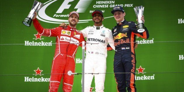 SHANGHAI, CHINA - APRIL 09: Race winner Lewis Hamilton (C) of Great Britain and Mercedes GP with second placed finisher Sebastian Vettel (L) of Germany and Ferrari and third placed finisher Max Verstappen (R) of Netherlands and Red Bull Racing on the podium during the Formula One Grand Prix of China at Shanghai International Circuit on April 9, 2017 in Shanghai, China. (Photo by Stringer/Anadolu Agency/Getty Images)