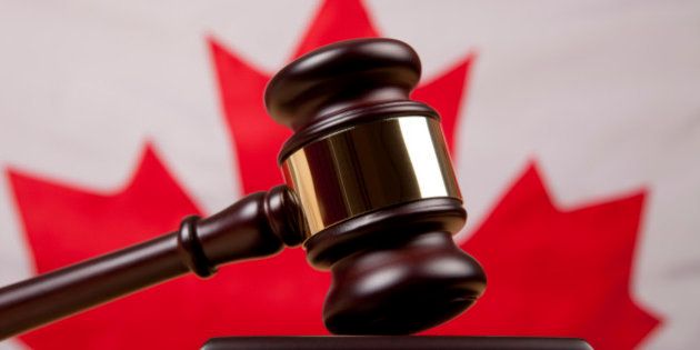 Gavel in front of Canadian flag representing Canadian legal and justice system.