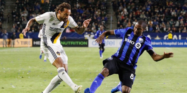 CARSON, CA - APRIL 07: Jermaine Jones #13 of the Los Angeles Galaxy attempts to kick the ball while Patrice Bernier #8 of the Montreal Impact slides into play during the Los Angeles Galaxy's MLS match against the Montreal Impact at the StubHub Center on April 7, 2017 in Carson, California. (Photo by Josh Lefkowitz/Getty Images)