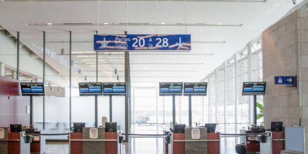 Empty Airport counters or boarding gates, Montreal, with bilingual signs in French and English
