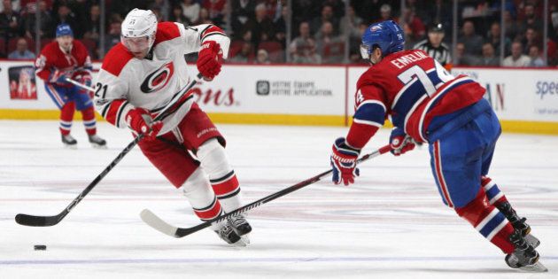 Mar 23, 2017; Montreal, Quebec, CAN; Carolina Hurricanes right wing Lee Stempniak (21) skates with the puck as Montreal Canadiens defenseman Alexei Emelin (74) defends during the second period at Bell Centre. Mandatory Credit: Jean-Yves Ahern-USA TODAY Sports