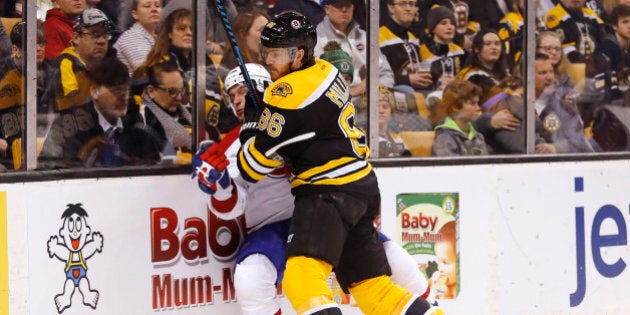 Feb 12, 2017; Boston, MA, USA; Boston Bruins defenseman Kevan Miller (86) checks Montreal Canadiens center Brian Flynn (32) during the first period at TD Garden. Mandatory Credit: Winslow Townson-USA TODAY Sports