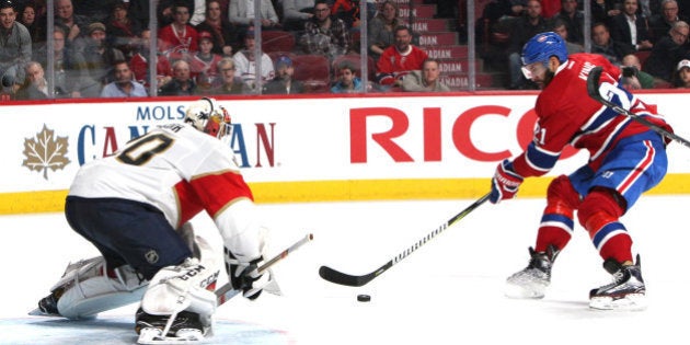 Mar 30, 2017; Montreal, Quebec, CAN; Montreal Canadiens left wing Dwight King (21) shoots the puck against Florida Panthers goalie Reto Berra (20) during the second period at Bell Centre. Mandatory Credit: Jean-Yves Ahern-USA TODAY Sports