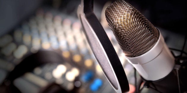 Recording equipment in studio. Studio microphone with headphones and mixer background. Elevated view