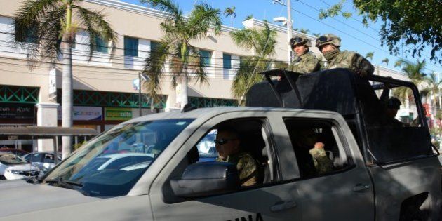 CANCUN, MEXICO - JANUARY 17: Marines patrol near the State Prosecutor Office where a group of gunmen attacked the place in Cancun, Mexico on January 17, 2017. Shootings left four people dead and five detainees. Cancun is one of the most iconic tourist destinations in Mexico, receiving millions of tourists a year from all around the world. (Photo by Stringer/Anadolu Agency/Getty Images)