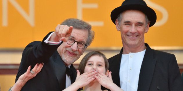 US director Steven Spielberg, US actress Ruby Barnhill and British actor Mark Rylance cheer on May 14, 2016 as they arrive for the screening of the film 'The BFG' at the 69th Cannes Film Festival in Cannes, southern France. / AFP / LOIC VENANCE (Photo credit should read LOIC VENANCE/AFP/Getty Images)