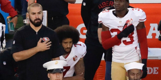 San Francisco 49ers quarterback Colin Kaepernick, middle, kneels during the national anthem before the team's NFL preseason football game against the San Diego Chargers, Thursday, Sept. 1, 2016, in San Diego. (AP Photo/Chris Carlson)