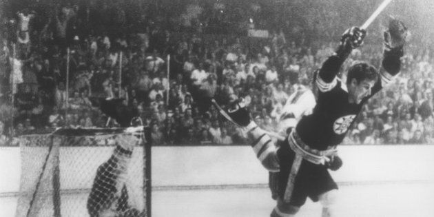 BOSTON, MA - MAY 10: Bobby Orr #4 of the Boston Bruins flies through the air after sliding the puck past goalie Glenn Hall and tripped by Noel Picard of the St. Louis Blues as Orr scored the game winning overtime goal during Game 4 of the Stanley Cup Finals on May 10, 1970 at the Boston Garden in Boston, Massachusetts. The Bruins defeated the Blues 4-3 and won the series 4-0. (Photo by Bruce Bennett Studios/Getty Images)