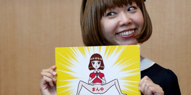 Japanese artist Megumi Igarashi, known as Rokudenashiko, holds her artwork after a news conference following a court appearance in Tokyo April 15, 2015. REUTERS/Toru Hanai/File Photo FOR EDITORIAL USE ONLY. NO RESALES. NO ARCHIVES. TPX IMAGES OF THE DAY