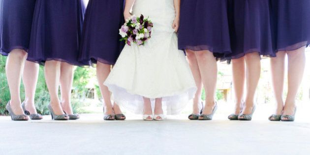 Six bridesmaid and bride standing.