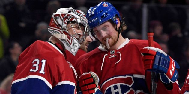 Dec 20, 2016; Montreal, Quebec, CAN; Montreal Canadiens goalie Carey Price (31) reacts with teammate Jeff Petry (26) after defeating the Anaheim Ducks 5-1 at the Bell Centre. Mandatory Credit: Eric Bolte-USA TODAY Sports