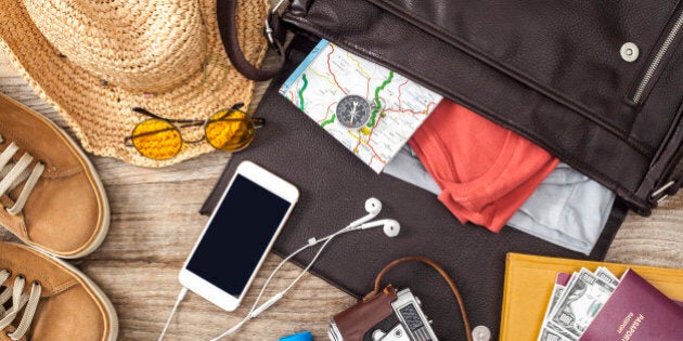 Holiday suitcase on wooden table