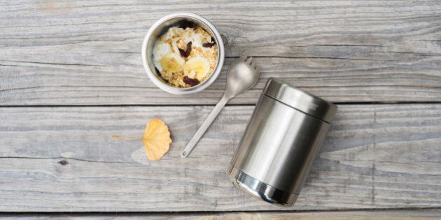 Breakfast to go outdoor style in an insulated mug. Fresh bananas, yogurt, and granola.