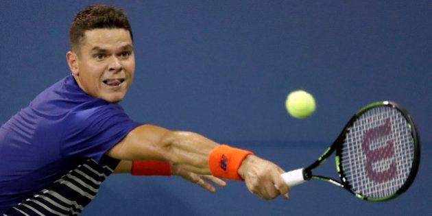 Milos Raonic, of Canada, returns a shot to Dustin Brown, of Germany, during the first round of the US Open tennis tournament, Monday, Aug. 29, 2016, in New York. (AP Photo/Julio Cortez)