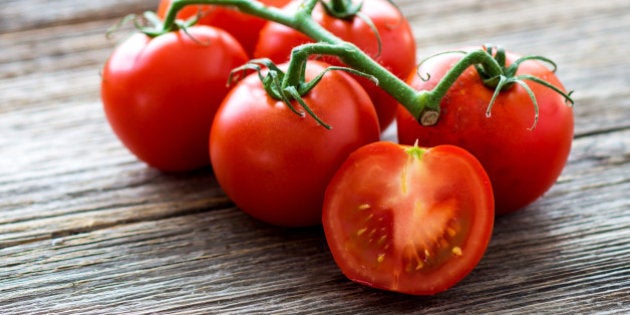 Fresh tomatoes on wood background