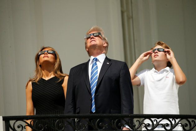 U.S. President Donald Trump watches the solar eclipse with first Lady Melania Trump and son Barron from the Truman Balcony at the White House in Washington, U.S., August 21, 2017 REUTERS/Kevin Lamarque