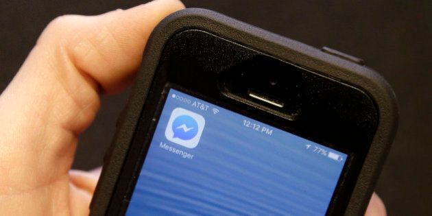 An Associated Press reporter holds a mobile phone showing the Facebook Messenger app icon in San Francisco, Wednesday, July 27, 2016. Facebook is pushing more people to install its Messenger application, now by blocking people who want to send and receive messages via its mobile website instead of the app. (AP Photo/Jeff Chiu)