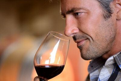15088928 - closeup on winemaker smelling red wine in glass