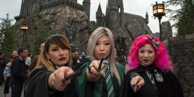 Fans pose in front of Hogwarts castle at the Grand Opening of the 'Wizarding World of Harry Potter' to the public at Universal Studios Hollywood, in Universal City, California, on April 7, 2016.Fifteen years after Harry Potter's first big screen adventure, Universal is enchanting a new generation of Muggles with its most spectacular conjuring trick yet -- a theme park in the heart of Hollywood. / AFP / VALERIE MACON (Photo credit should read VALERIE MACON/AFP/Getty Images)