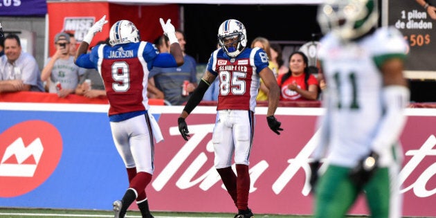 MONTREAL, QC - JUNE 22: Wide receiver B.J. Cunningham #85 of the Montreal Alouettes celebrates his touchdown with teammate wide receiver Ernest Jackson #9 against the Saskatchewan Roughriders in the first half during the CFL game at Percival Molson Stadium on June 22, 2017 in Montreal, Quebec, Canada. (Photo by Minas Panagiotakis/Getty Images)