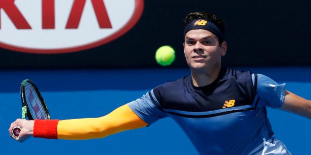 Milos Raonic of Canada reaches for a forehand return to Lucas Pouille of France during their first round match at the Australian Open tennis championships in Melbourne, Australia, Tuesday, Jan. 19, 2016.(AP Photo/Vincent Thian)