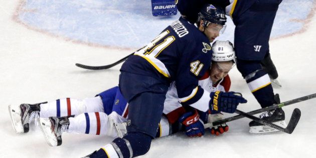 St. Louis Blues' Robert Bortuzzo (41) and Montreal Canadiens' Lars Eller, of Denmark, keep their eyes on the puck during the second period of an NHL hockey game Saturday, Jan. 16, 2016, in St. Louis. (AP Photo/Jeff Roberson)